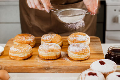 Midsection of woman preparing food on table