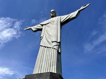 Low angle view of statue against blue sky