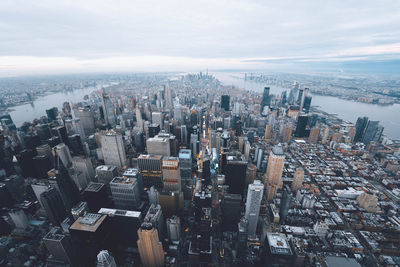 High angle view of modern buildings in city against sky