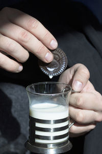 Close-up of hand holding coffee cup