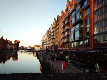 Buildings by river against sky during sunset.  old city in the evening 