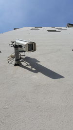 Security cam on a wall in a sunny day