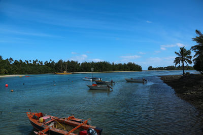 Boats moored on river against sky