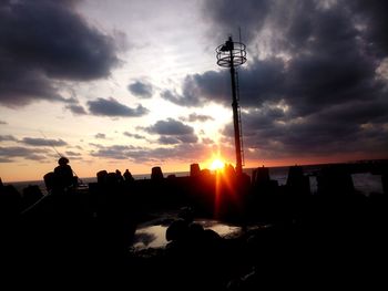 Silhouette tower against sky during sunset