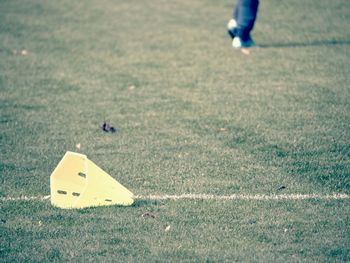 Low section of man playing soccer on field