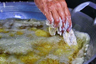 Close-up of person preparing food in kitchen