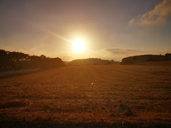 Scenic view of field against sky during sunset