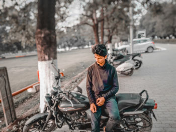 Man riding bicycle on street in city