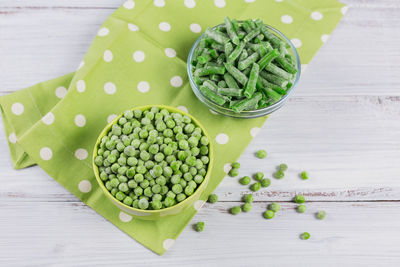 Composition with different organic frozen vegetables on a white background