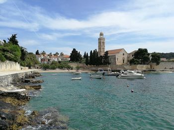 Panoramic view of water and buildings against sky