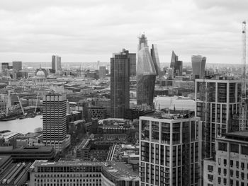 Aerial view of buildings in city against sky