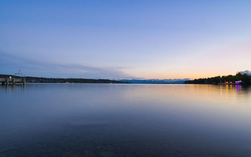 Scenic view of lake against sky during sunset