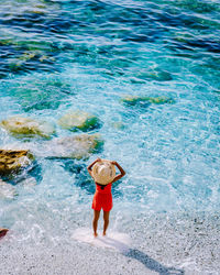 High angle view of man standing in swimming pool