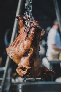 Close-up of roasted meat hanging in kitchen