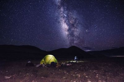 Scenic view of tent against sky at night