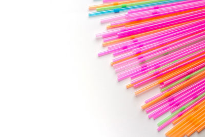 High angle view of colored pencils against white background