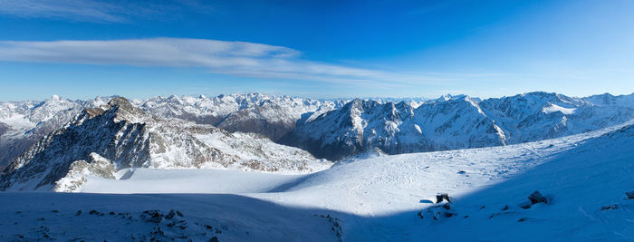 Scenic view of snow covered landscape against blue sky