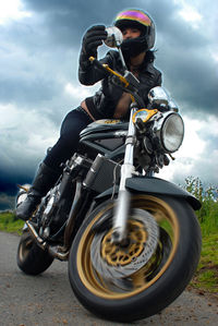 Man riding motorcycle against sky