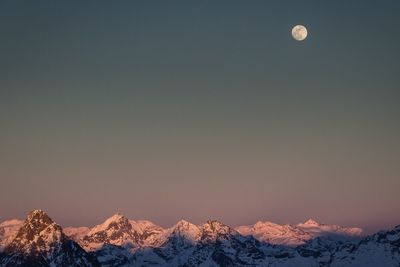 Scenic view of snowcapped mountains against clear sky