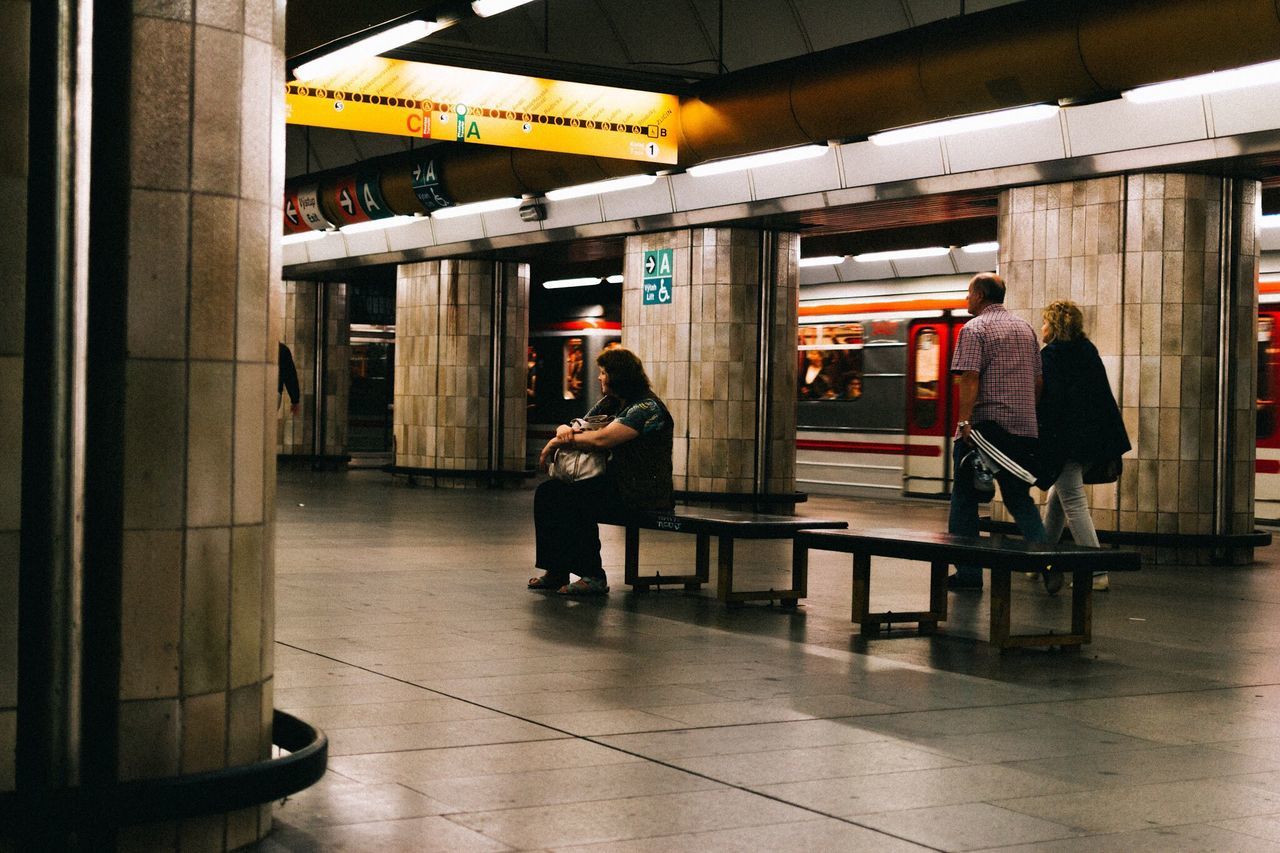 PEOPLE SITTING IN TILED FLOOR