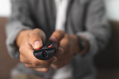 Close-up of man holding mobile phone