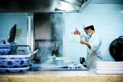 People working in kitchen