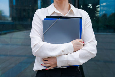 Business caucasian woman holding paper folder file smiling and feeling