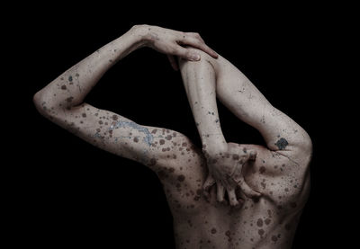 Close-up of human hand against black background