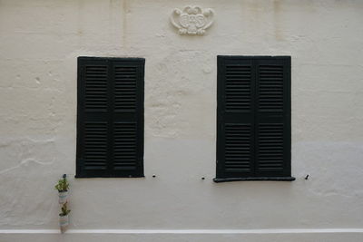 Black windows on white wall