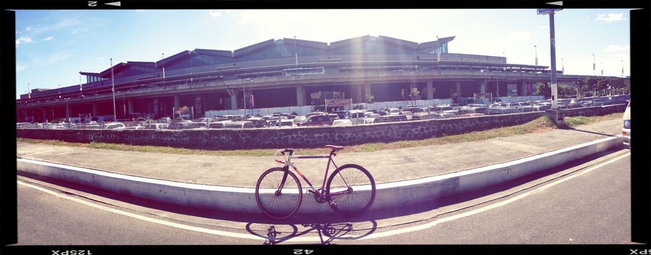 transfer print, transportation, architecture, built structure, mode of transport, building exterior, auto post production filter, land vehicle, bicycle, city, sky, stationary, street, travel, railing, car, incidental people, day, parked, outdoors