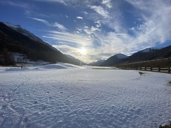 Scenic view of snow covered mountains against sky