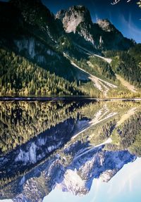 Scenic view of calm lake with mountains reflection