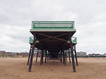 Low angle view of pier on beach