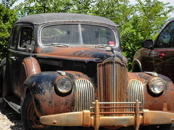 Abandoned car against sky