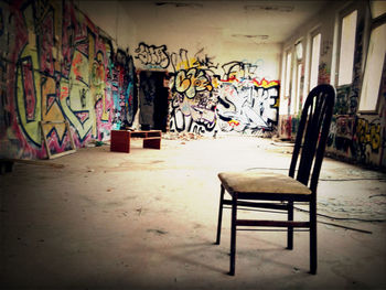 Empty chairs in front of wall