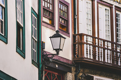 Low angle view of street light by building