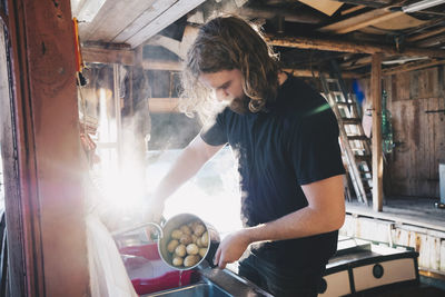 Young man working in kitchen