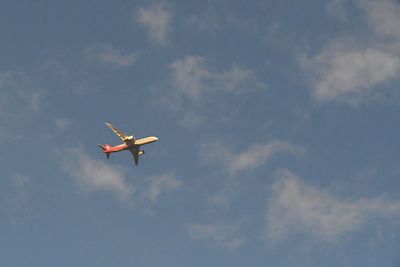 Low angle view of airplane flying in sky