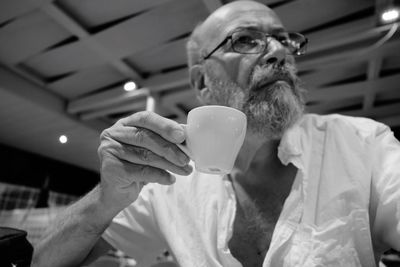 Senior man holding coffee cup