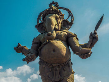 Low angle view of statue against blue sky