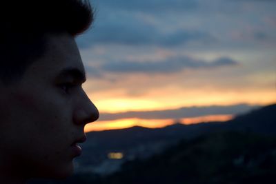 Close-up of man against sky during sunset