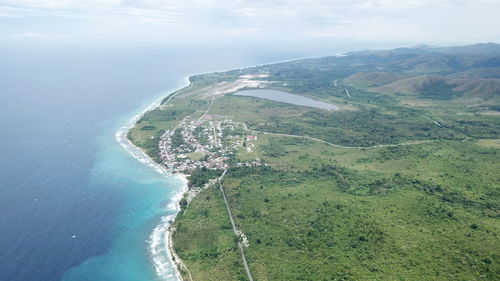 Aerial view of sea and mountains against sky