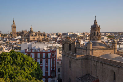 Panoramic view of buildings in city against clear sky