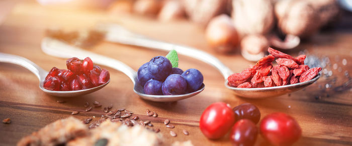 High angle view of fruits and seeds on wooden table