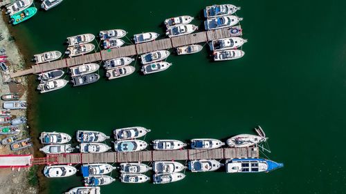 Directly above shot of yachts moored at piers on river