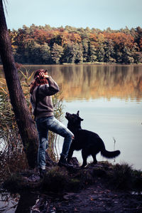 Woman with dog at lake