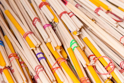 Close-up of candles and incense sticks for sale at market stall