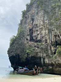 Group of people on rock by sea