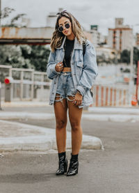 Full length of young woman standing outdoors