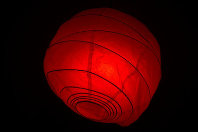 Low angle view of lantern against black background